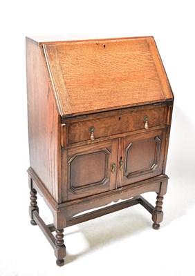 Lot 20 - A mid-20th century oak student bureau with...