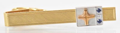 Lot 1309 - A yellow metal diamond and blue stone set tie...