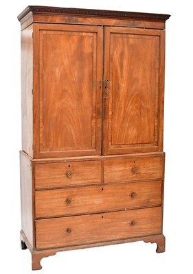 Lot 55 - A George III mahogany linen press with dentil...