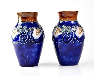 Lot 295 - ROYAL DOULTON; a pair of stoneware vases...
