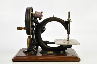 Lot 1655 - WILCOX & GIBBS; a vintage sewing machine, with...