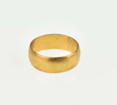Lot 987 - A 22ct gold wide wedding band, size K, approx....