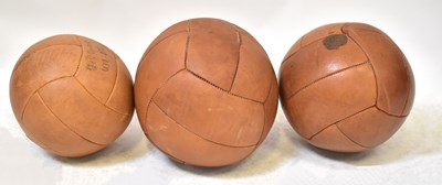 Lot 580 - Three vintage tan leather medicine balls (3).