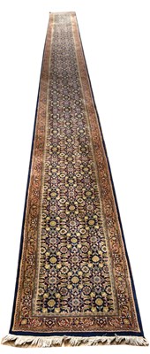 Lot 1439 - A large Eastern runner with stylised floral...