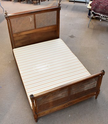 Lot 1684 - A French walnut and cane work bedstead, width...