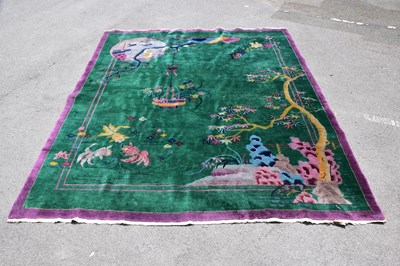 Lot 1475 - MAPLE & CO; a 1920s Chinese carpet on green...