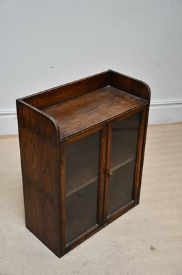 Lot 1329 - A small 1920s oak two door cabinet, with...