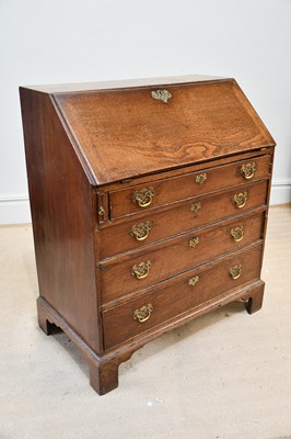 Lot 1383 - A George III oak bureau, with four graduated...