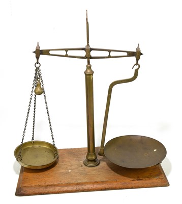 Lot 29 - A set of brass balance/beam scales, raised on...