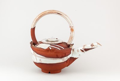 Lot 5 - ADAM TOBIN; a large red stoneware teapot...