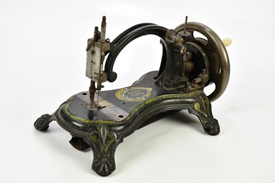 Lot 1664 - THE LITTLE HOWE; a sewing machine, with gilt...