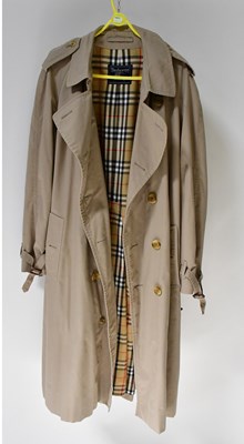 Lot 670 - BURBERRY; a tan overcoat with tartan lining,...