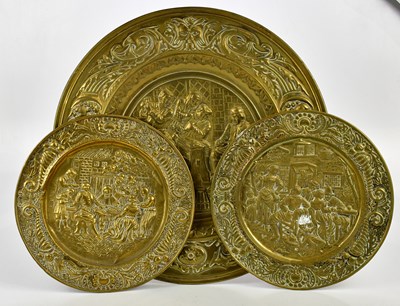 Lot 1742 - Three brass wall chargers, each with embossed...