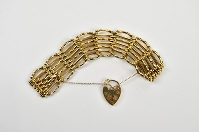 Lot 410 - A yellow metal gate link bracelet with 9ct...