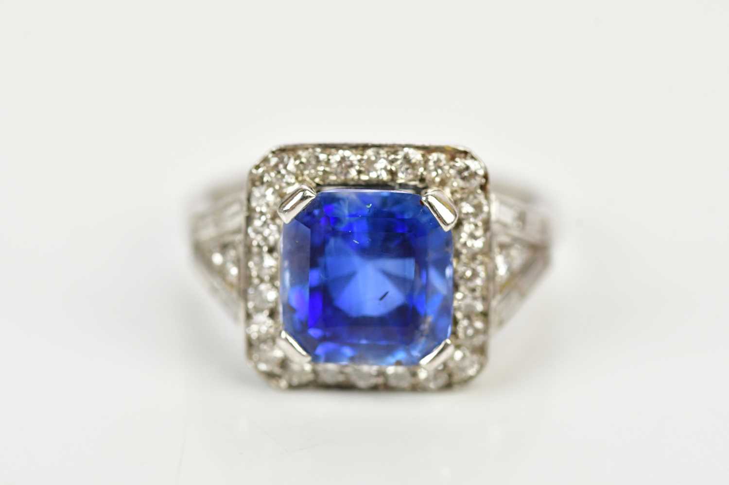 Lot 26 - A white metal diamond and sapphire dress ring...