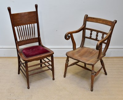 Lot 1297 - An American carved oak hall chair with spindle...