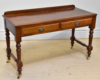 Lot 1322 - An Edwardian walnut writing table with two...