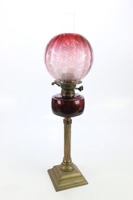 Lot 1805 - A late Victorian oil lamp with cranberry/clear...