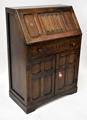 Lot 46 - A 1930s carved oak bureau with linenfold...
