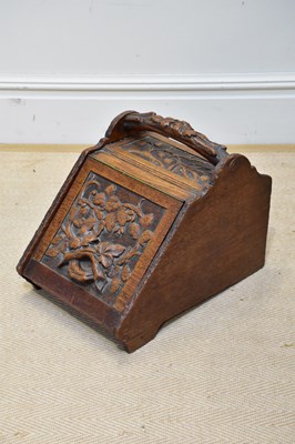 Lot 1324 - A Victorian carved oak coal scuttle with liner.