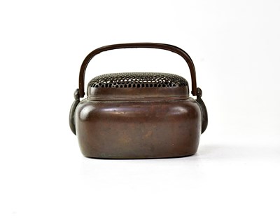 Lot 232 - A copper hand warmer, the pierced grille with...
