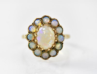 Lot 871 - A 9ct gold floral cluster ring, the central...