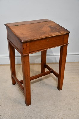 Lot 1312 - A stained pine school desk with sloping top,...