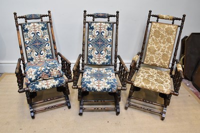 Lot 1302 - Three American type rocking chairs upholstered...