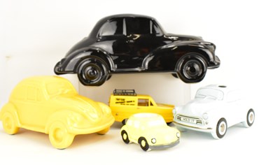 Lot 416 - Four ceramic and plastic ornamental cars,...