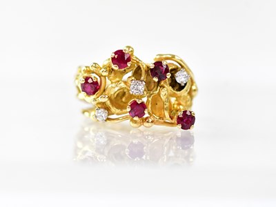 Lot 1080 - An 18ct gold ring in the form of intertwined...