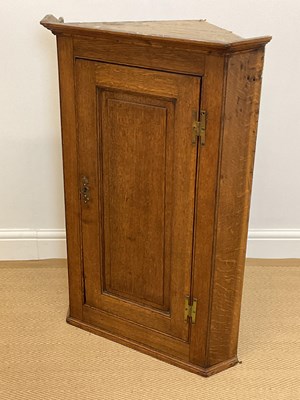 Lot 584 - A George III oak flat fronted hanging corner...