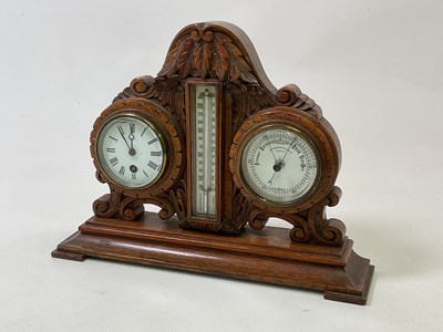 Lot 423 - An early 20th century carved oak table clock...