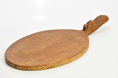 Lot 2027 - ROBERT MOUSEMAN THOMPSON; an oak cheeseboard...