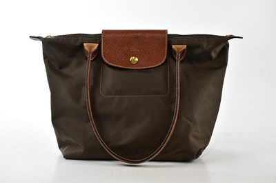 Lot 779 - LONGCHAMPS; a brown Le Pliage small handbag...