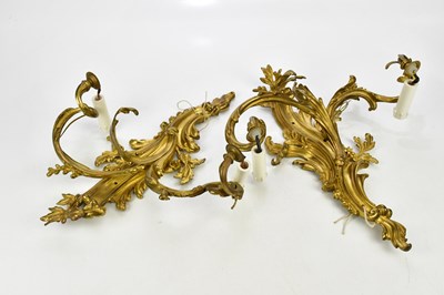 Lot 1791 - A pair of Rococo style gilt bronze twin branch...