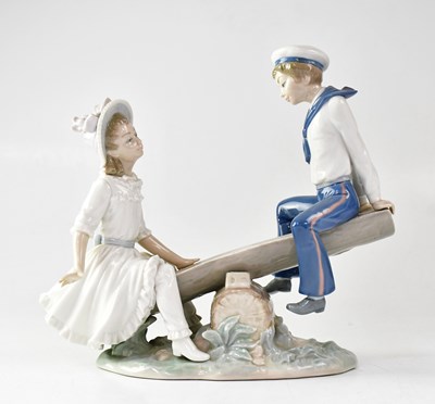 Lot 267 - LLADRÓ; a figure group of two children on a...