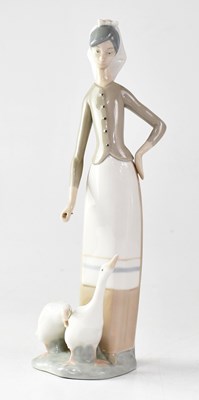 Lot 484 - LLADRÓ; a figure group of a young lady feeding...