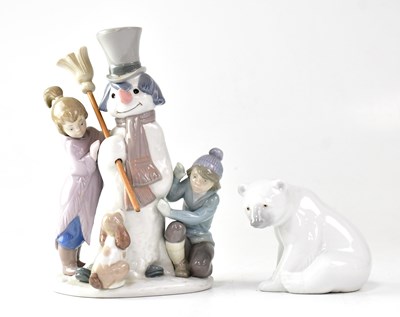 Lot 240 - LLADRÓ; a figure group of a snowman with two...