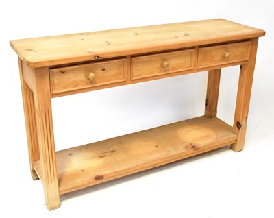Lot 42 - A pine dresser with three drawers above open...