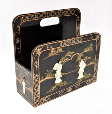 Lot 11 - A contemporary black lacquered magazine rack...