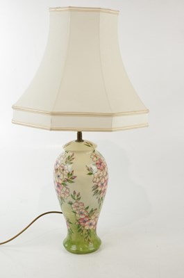 Lot 2777 - MOORCROFT; a decorative table lamp, tubelined...