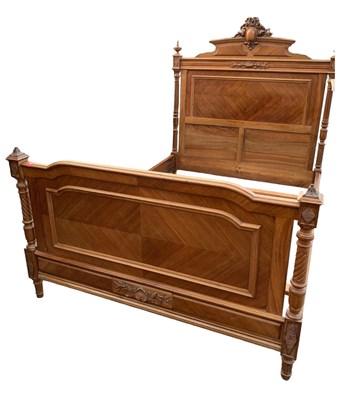 Lot 1357 - A French carved walnut bed, the headboard with...