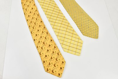 Lot 795 - HERMÈS; three 100% silk yellow ties including...