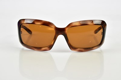 Lot 825 - CHANEL; a pair of brown tortoiseshell rimmed...