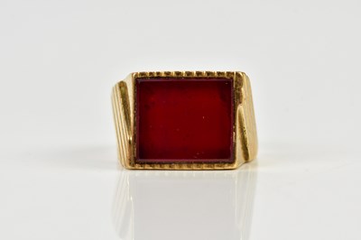 Lot 93 - A yellow metal signet ring set with red stone,...