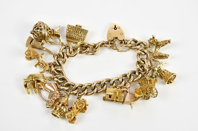 Lot 394 - A substantial 9ct yellow gold charm bracelet,...