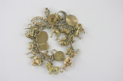 Lot 395 - A substantial 9ct gold charm bracelet, approx...