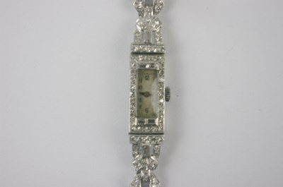 Lot 557 - A platinum and diamond Art Deco cocktail watch,...