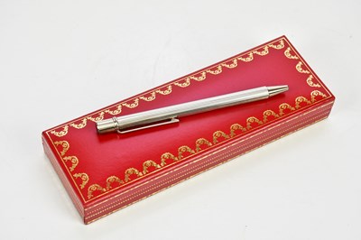 Lot 813 - MUST DE CARTIER; a silver twist ballpoint pen...