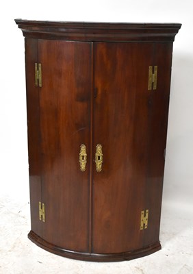 Lot 1561 - An 18th century mahogany corner cupboard with...